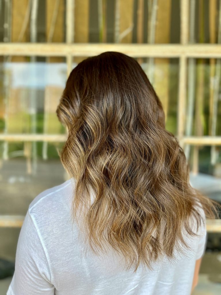 the back of a woman's head in front of a window